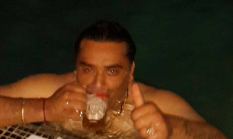 A photo of Jugnu Walia drinking beer in a pool