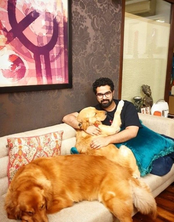 A photo of Siddharth Mahadevan playing with his dogs, Honey and Kiwi