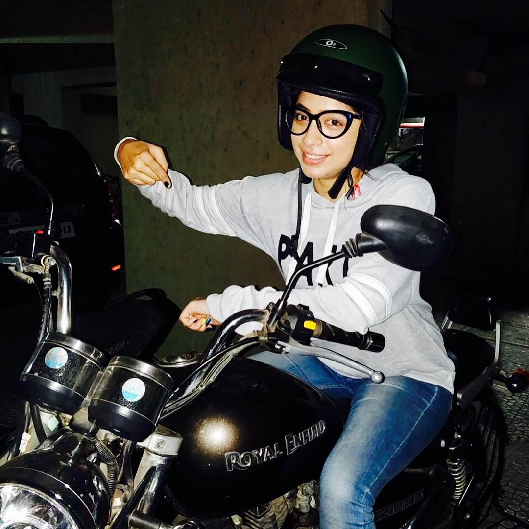 A photo of Snehal Rai riding her Royal Enfield Bullet motorcycle