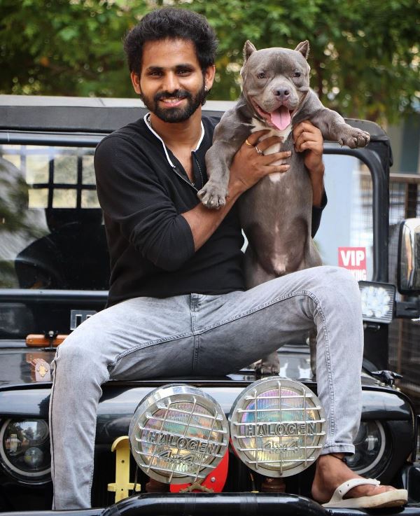 A photograph of of Sadda M Hussain with his pet dog