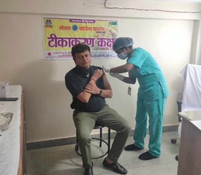 Ajay Alok taking the Covid-19 vaccine