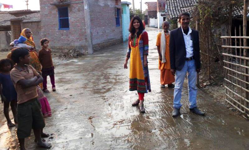 An image of Ritu Jaiswal posing on a newly constructed road in Singhwahini