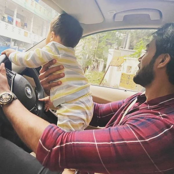 Arav and his baby in his BMW car