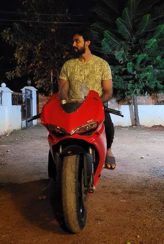 Arav posing with his bike