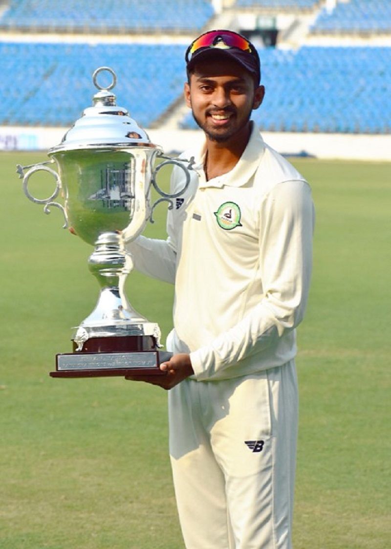 Atharva Taide holding the Irani Trophy