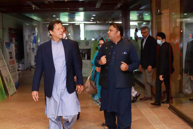 Fawad Chaudhry (right) with Imran Khan