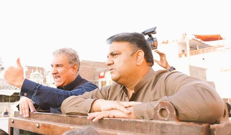 Fawad Chaudhry (right) with Shah Mahmood Qureshi during a political rally