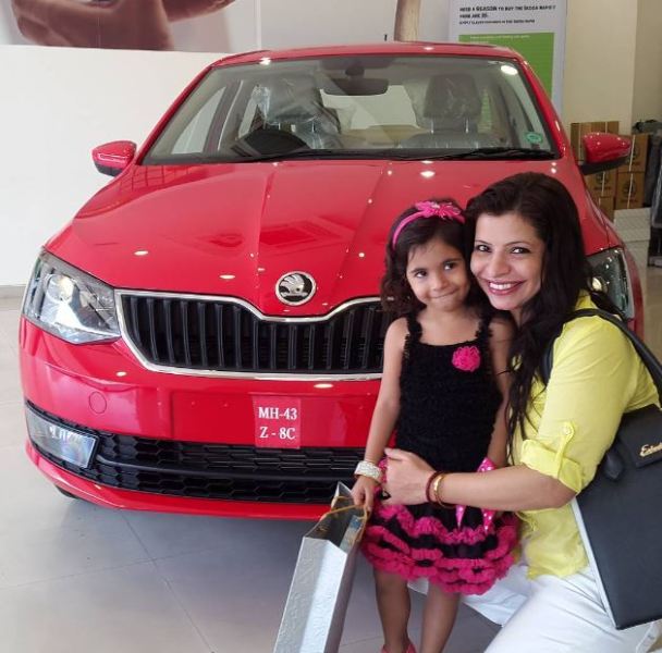 Jennifer Mistry Bansiwal posing with her daughter and new car