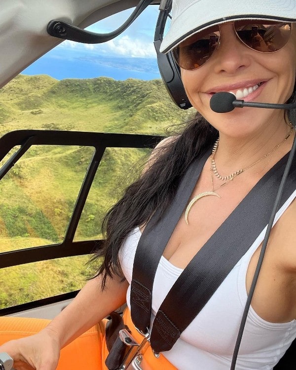 Lauren taking a selfie while flying a helicopter