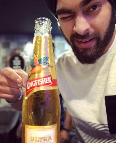 Manjot Singh with a bottle of beer