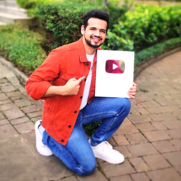 Mayur Jumani posing with his Silver Play Button