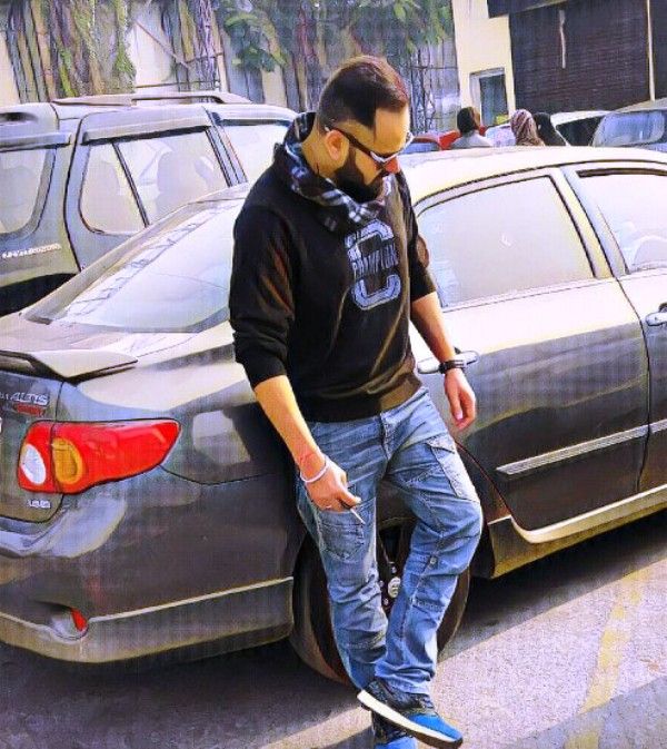 RJ Purab standing near his car