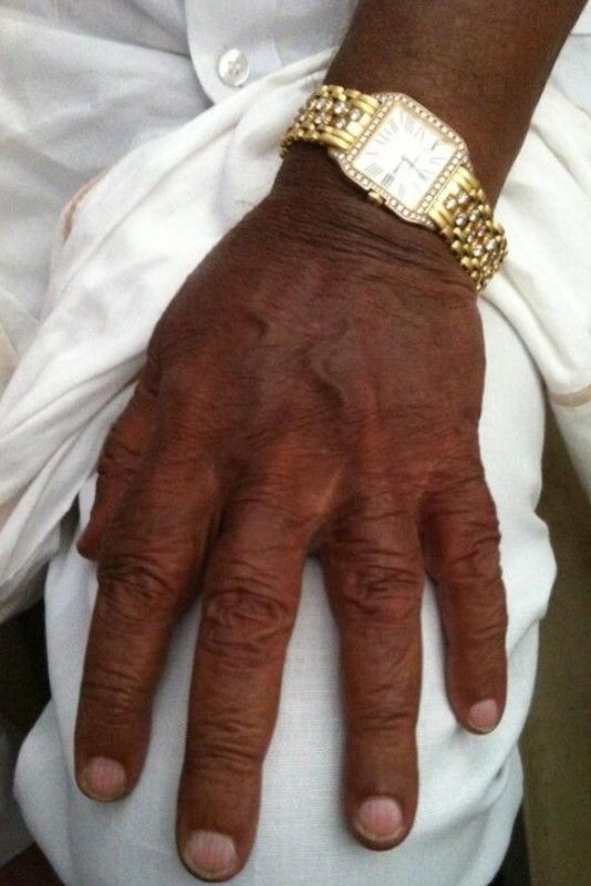 Shamanur Shivashankarappa has a diamond and gold Cartier watch