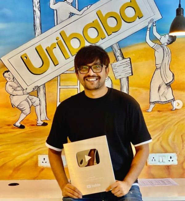 Sourav Chakraborty while holding a gold YouTube Plaque