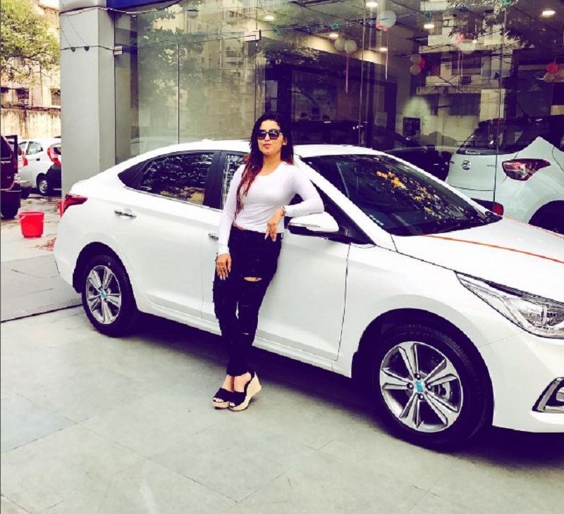 Sudipta Banerjee posing with her car