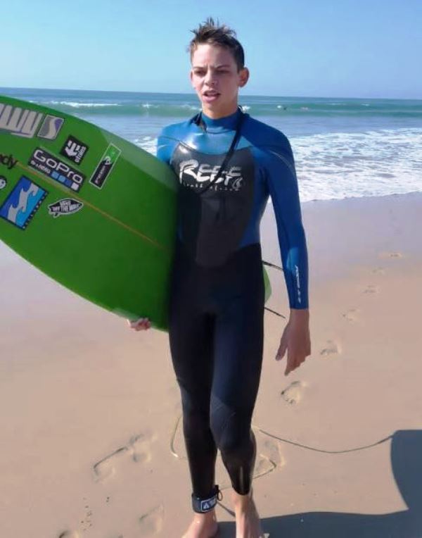 Teenagehood picture of Tristan Stubbs with his surfing board