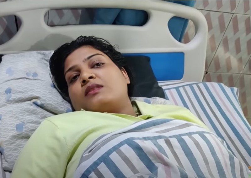 A photo of Nisha Upadhyay resting in the hospital during treatment of bullet wound