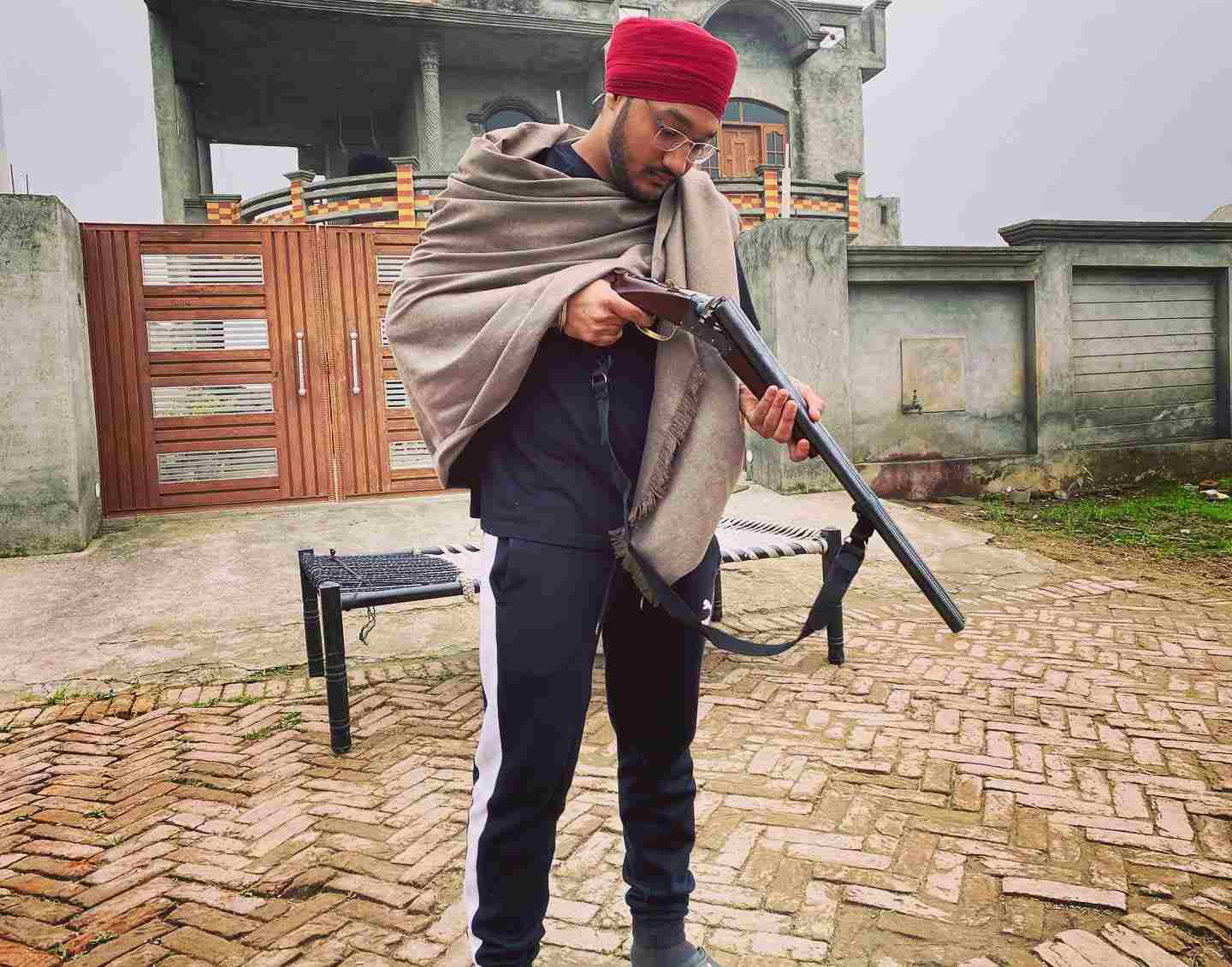 A photo of Riar Saab with a gun