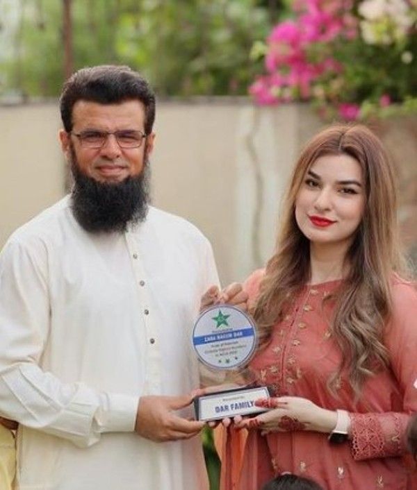 Aleem Dar giving the family trophy to his niece Zara Naeem Dar