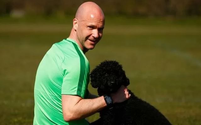 Anthony Taylor playing with his dog