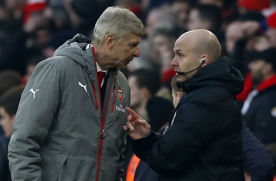 Anthony Taylor (right) having a verbal spat with Arsenal manager Arsene Wenger