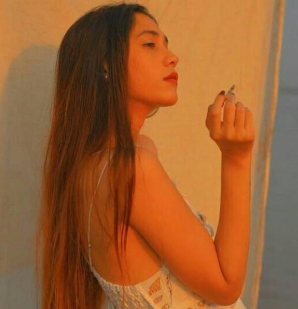 Anushka Mitra holding a cigarette