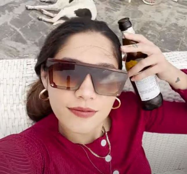 Anushka Mitra with a bottle of beer