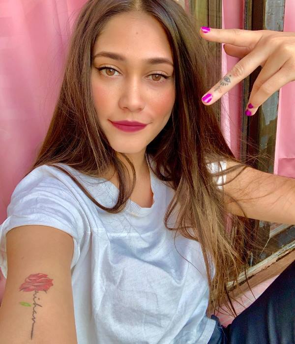 Anushka Mitra's tattoo on her right arm and left hand's middle finger