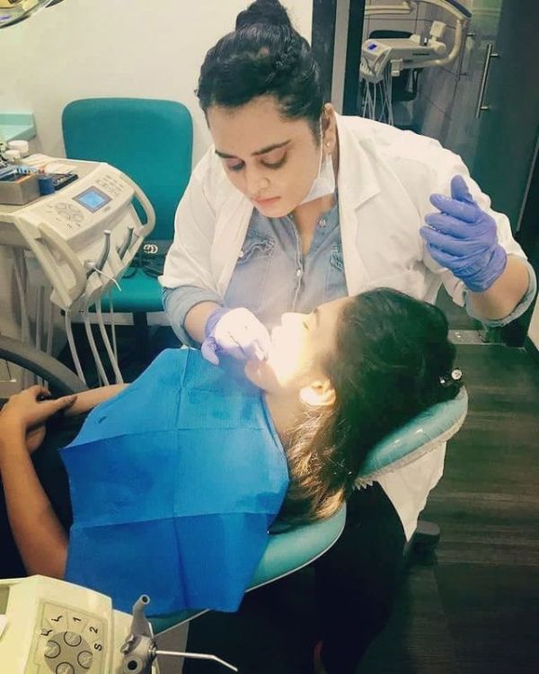 Bebika Dhurve while treating a patient at a dental clinic