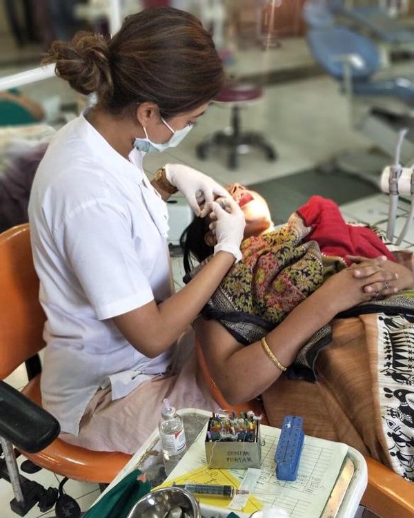 Gayatri attending to a patient during one of her dental camps