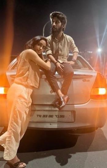 Jaffer Sadiq sitting on his Skoda Octavia car with his girlfriend, Sidhiqa Sherin