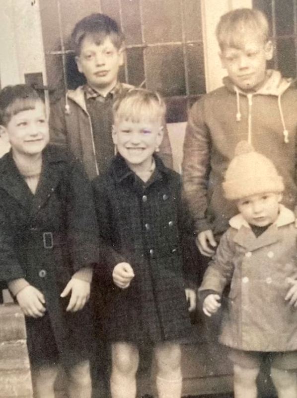 Julian Sands (in the middle, smiling) with his four brothers on the back porch of his house in Adel, Yorkshire, England