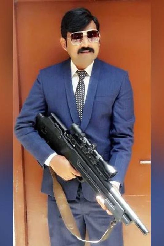 Khan Mubarak posing with a gun