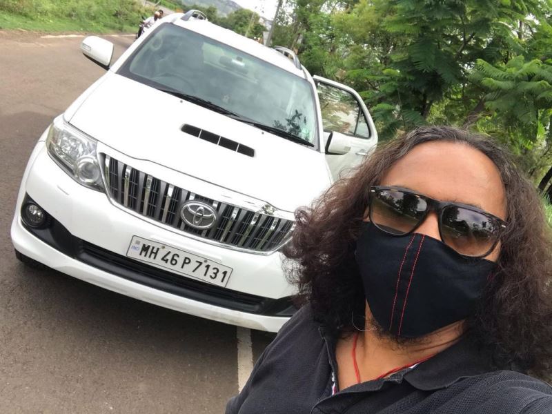 Prasad Sutar posing with his Toyota Fortuner