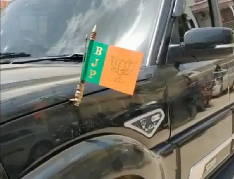 Priyansh Vishwakarma's scorpio with a BJP flag on it