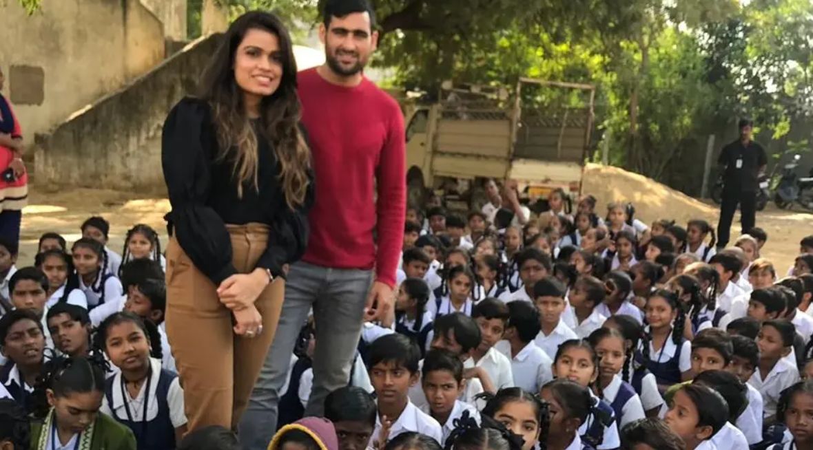 Rahul and his wife at a school