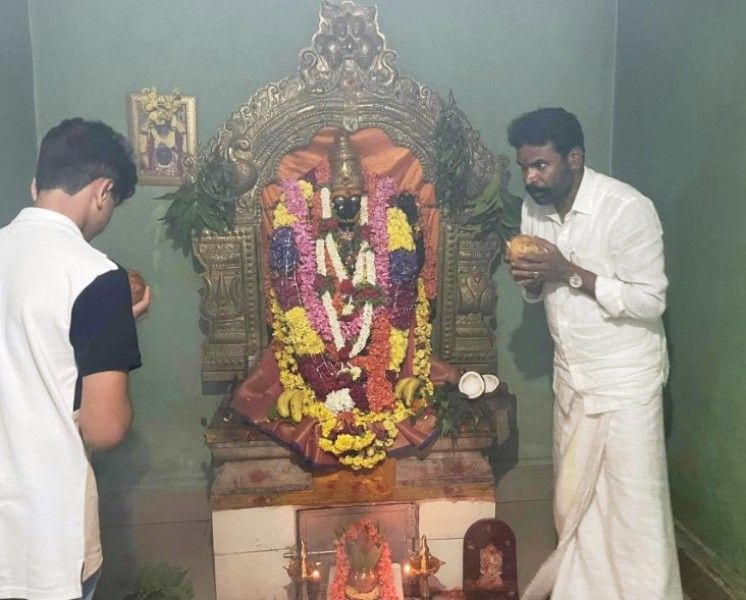 S. Muniswamy worshipping in a temple