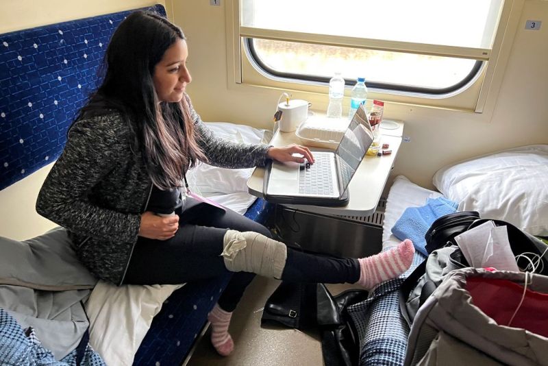 Sabrina Siddiqui pumping breast milk and working on the train from Kyiv back to Rzeszów, Poland, while keeping her leg elevated after a fall at Mariinsky Palace