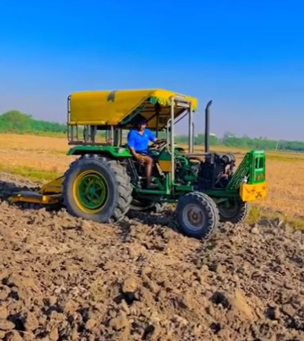 Sandeep Narwal driving a tractor on the field