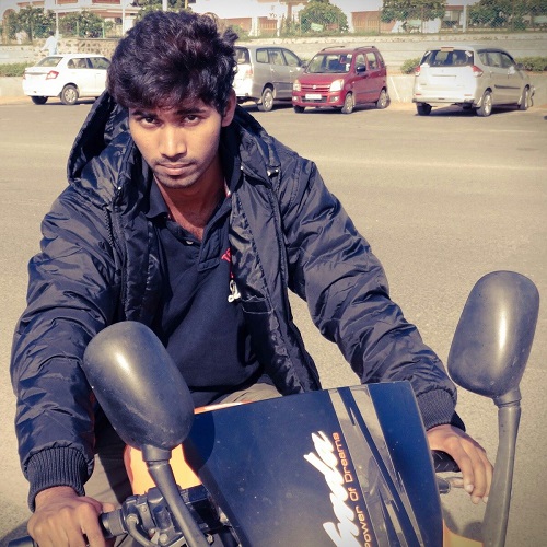 Saran Raj sitting on his motorcycle