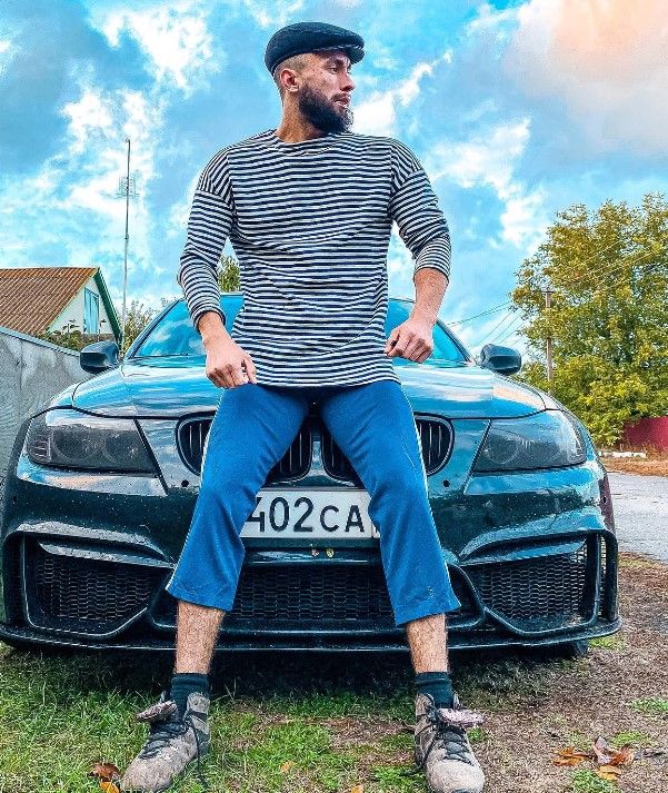 Vladimir Shmondenko posing in front of his BMW E90 car