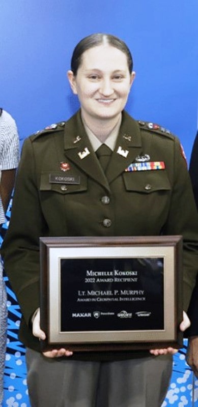 A US Army soldier holding the Lt. Michael P. Murphy Award in Geospatial Intelligence