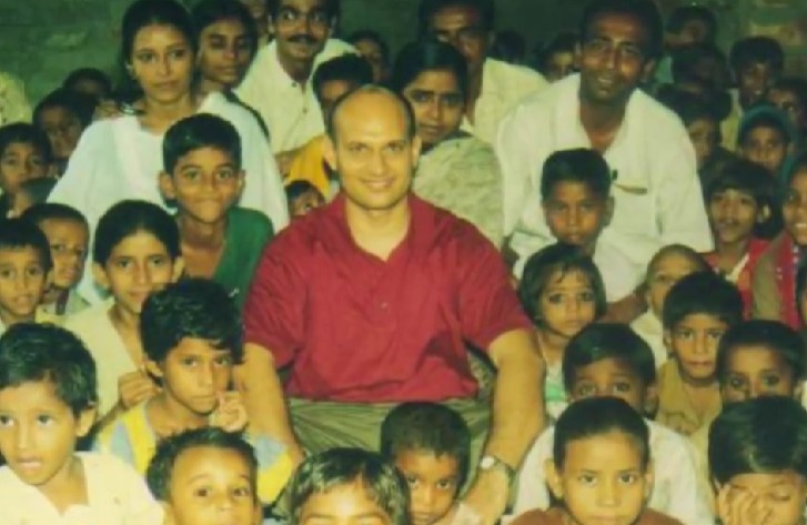 A young Ashish Kacholia posing with a group of deprived children