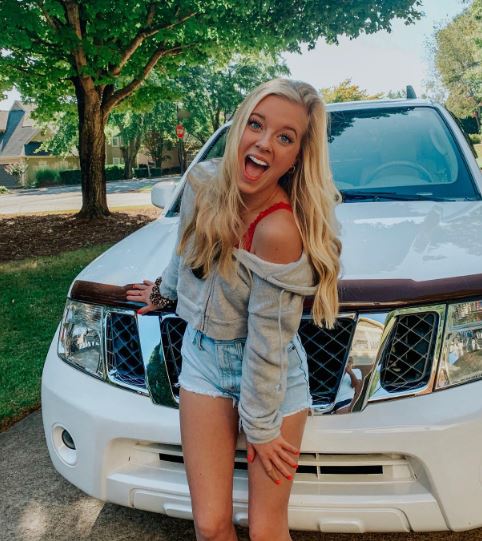 Annabelle Ham posing with her car