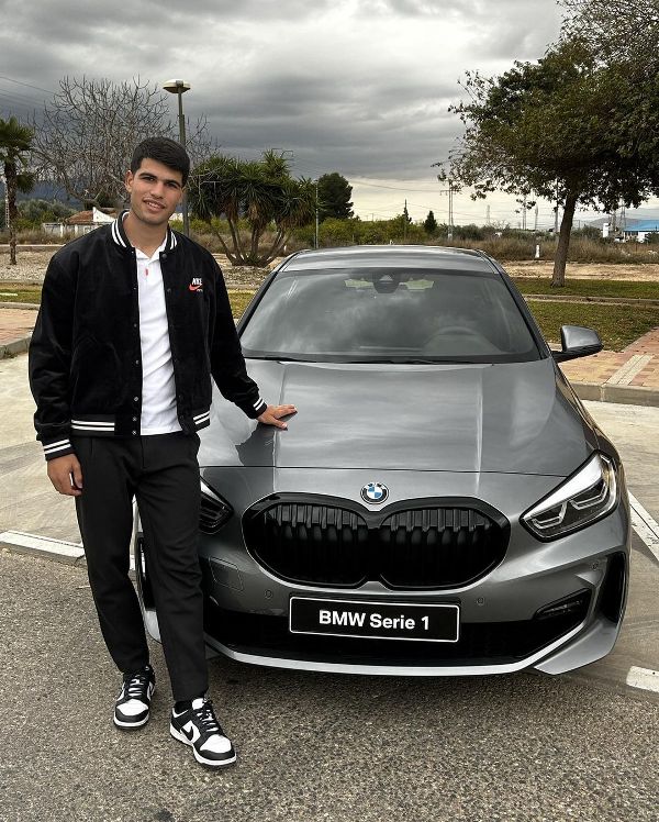 Carlos Alcaraz with his BMW 1 Series car