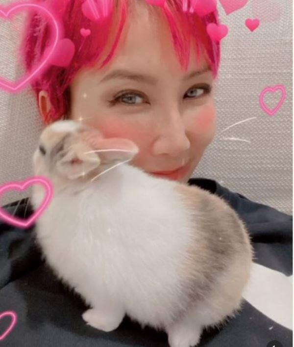 Coco Lee with her pet rabbit