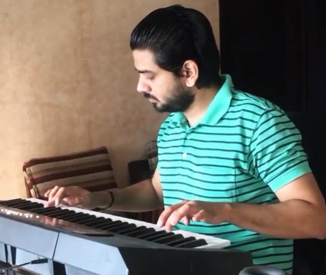 Ishan Mishra while playing a synthesizer