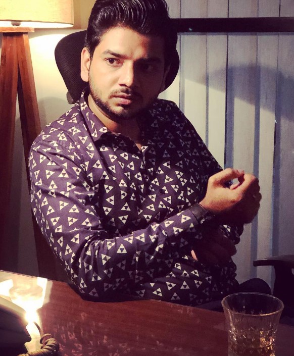Ishan Mishra with a glass of alcohol