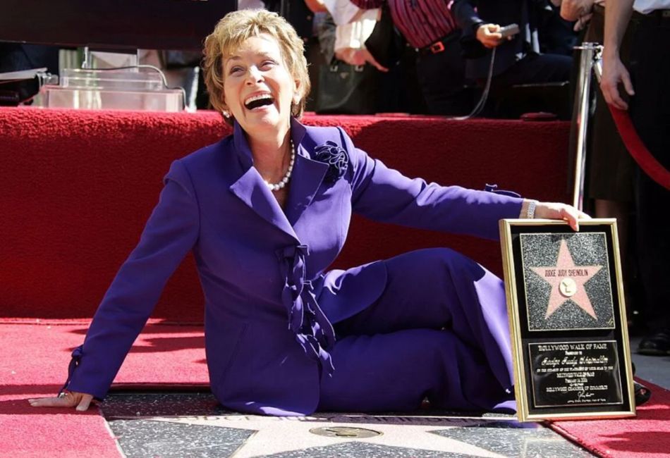 Judge Judith Sheindlin sitting next to her star on the Hollywood Walk of Fame
