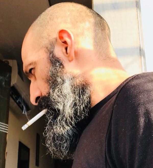 Mahesh Balraj smoking a cigarette
